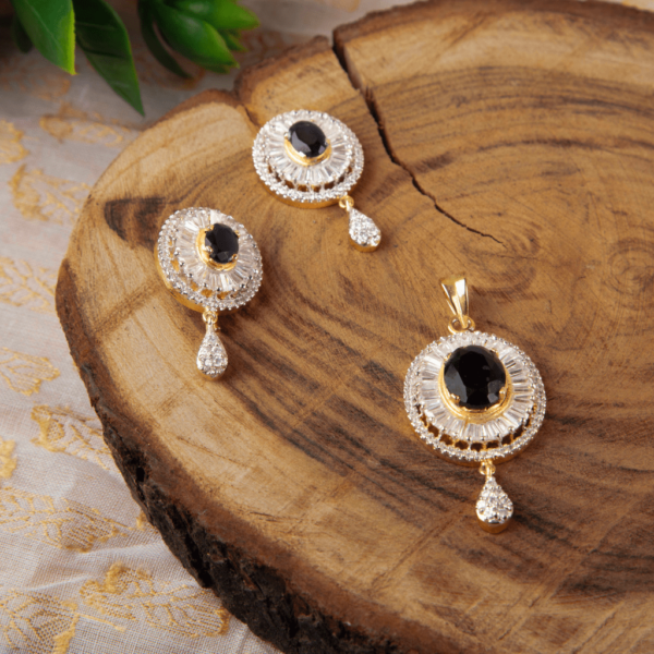 The Golden Elegance Pendant Set by Gift Elegantly features a central stone, golden frame, and diamond accents for a luxurious and traditional look. Perfect for special occasions.