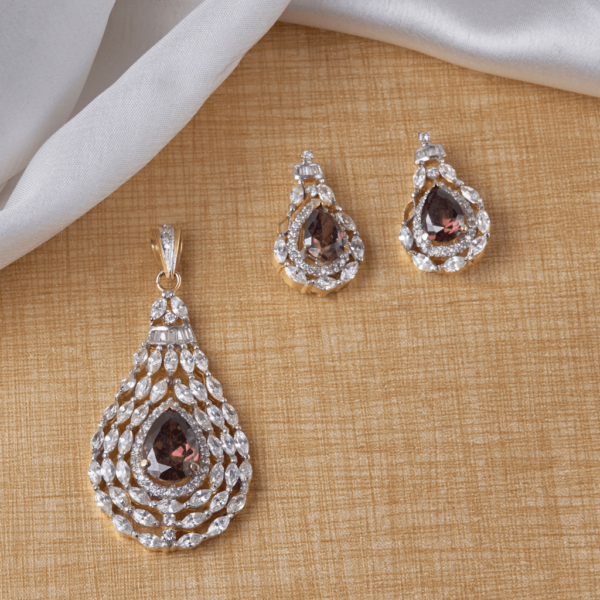 Gift Elegantly's Amber Glaze Pendant Set features marquise-shaped and baguette diamonds with a deep orange stone, perfect for special occasions.