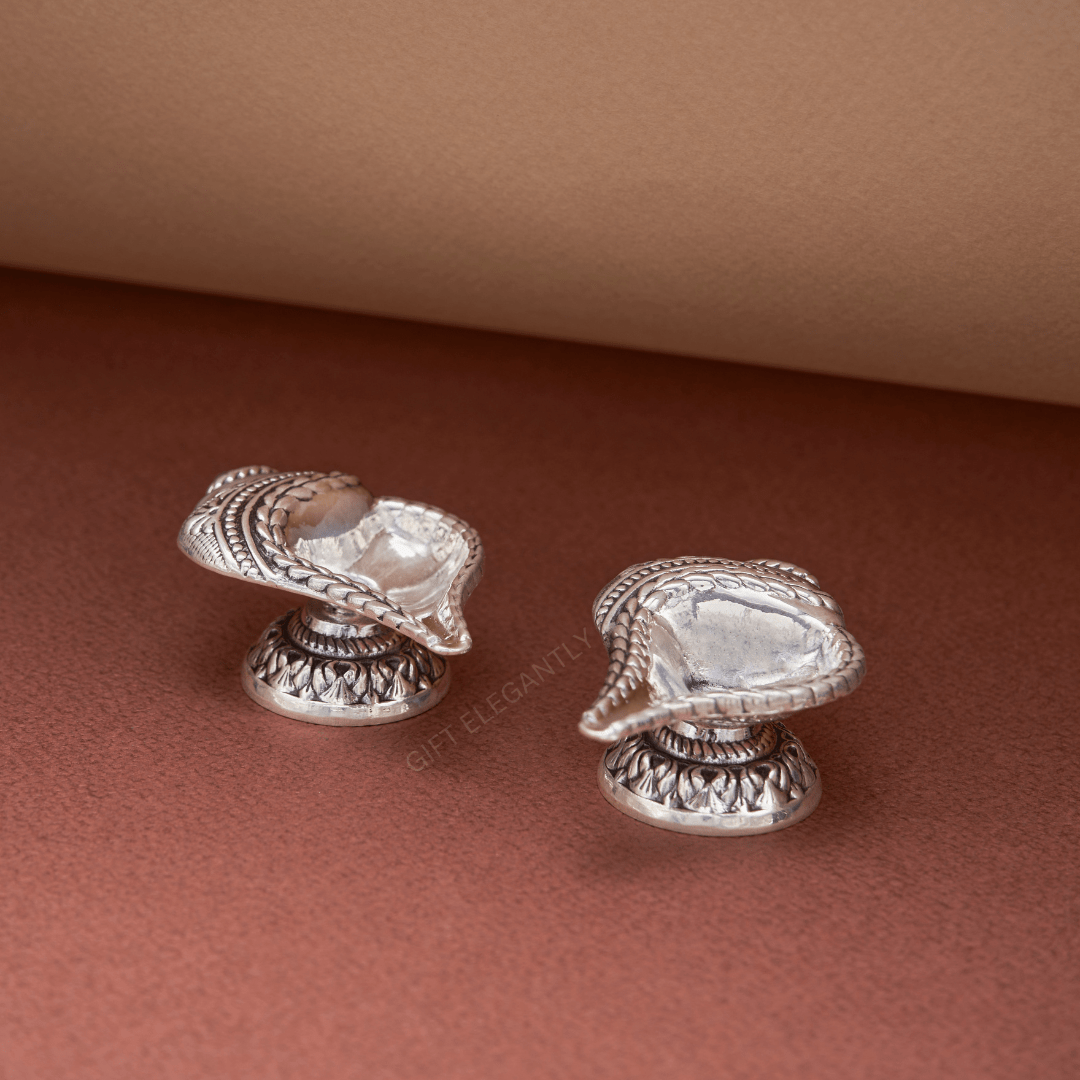 Set of 2 Silver Shell Shankh Diyas in 925 sterling silver with oxidized finish, perfect for home puja and gifting.