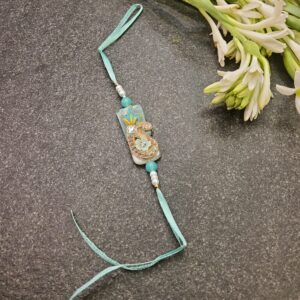 Aqua Resham Jardosi Rakhi featuring intricate Resham, Jardosi, and stone work with delicate pearls