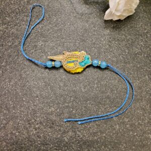 Blue Yellow Stone Rakhi featuring intricate Jardosi and Resham work with a beautiful stone centerpiece