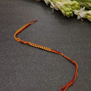 Knitted moli rakhi with golden beads