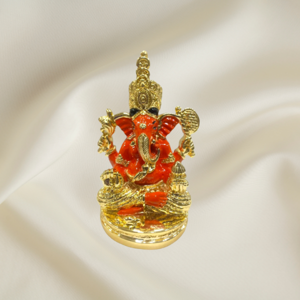 "Divine Majesty Ganesha Murti - 4-inch marble dust idol with gold coating and red enamel accents"