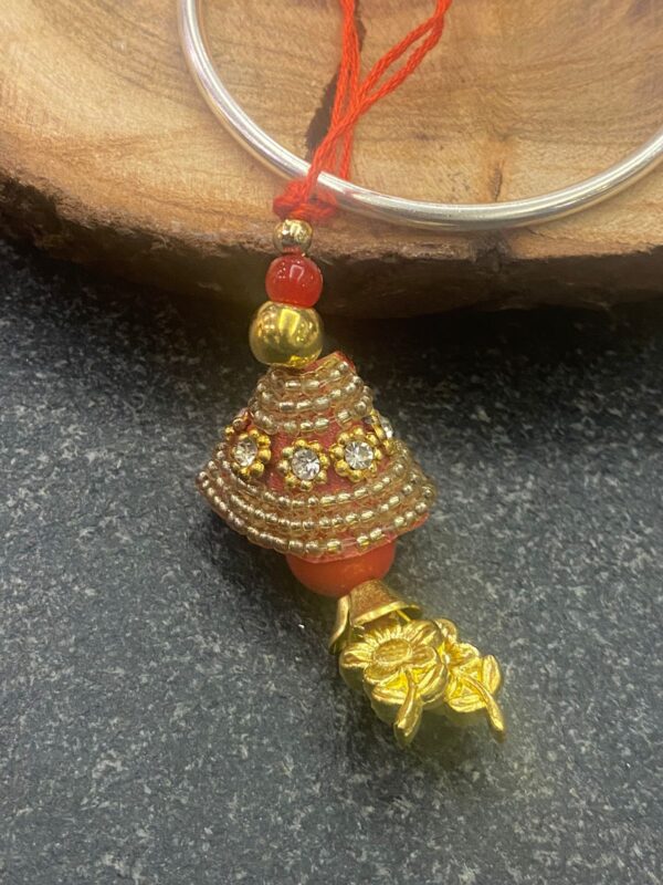 Handcrafted Golden Work Bhabhi Rakhi (गोल्डन वर्क भाभी राखी) with red thread and floral charm