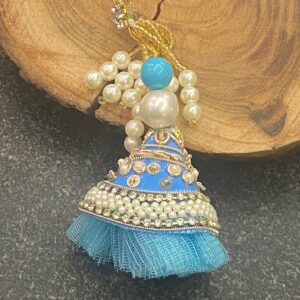 Handcrafted Blue Pearl Bhabhi Rakhi (ब्लू पर्ल भाभी राखी) with blue fabric, white beads resembling pearls, and floral charm