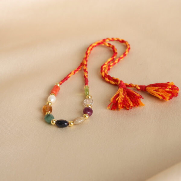 Navratna Silver Bead Rakhi with vibrant red and yellow threads