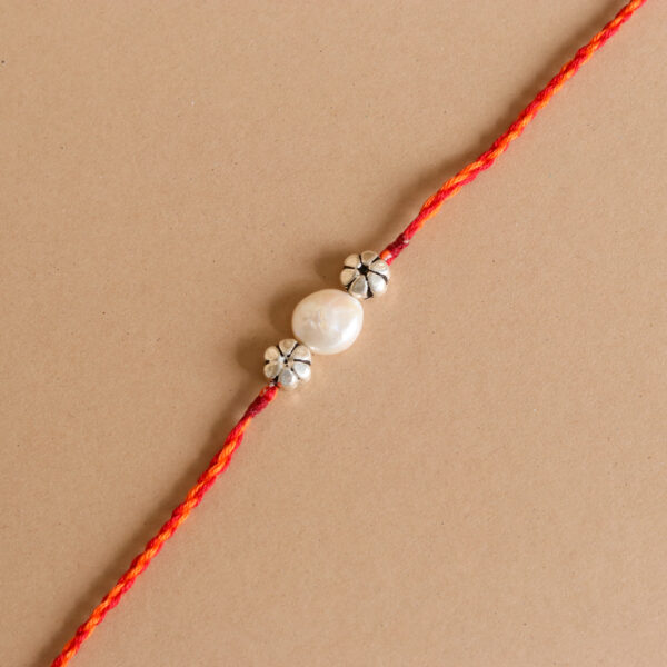 Pearl Silver Bead Rakhi with vibrant red thread