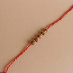 Golden Rudraksh Bead Rakhi with vibrant red and yellow threads