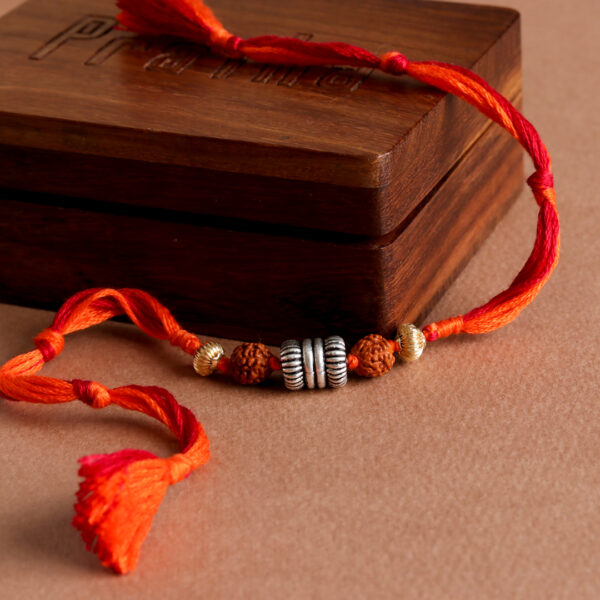 Silver Rudraksh Bead Rakhi with vibrant orange threads