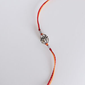 Classic Silver Moli Rakhi with vibrant red and yellow threads