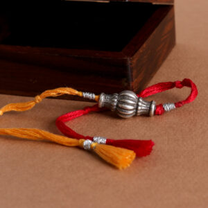 Vintage Silver Moli Rakhi with vibrant red and yellow threads