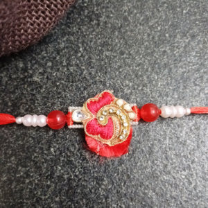 Red Floral Bhai Rakhi with intricate resham work, stones, and pearls