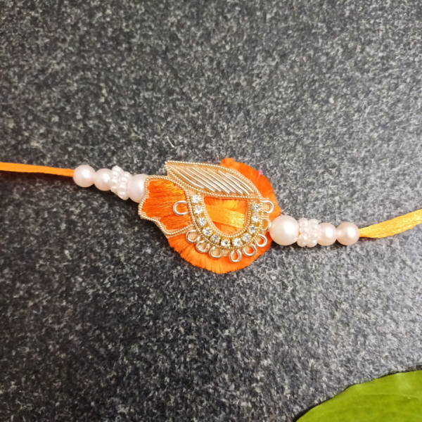 Orange Resham Floral Rakhi with stone, pearls, and Jardosi work.