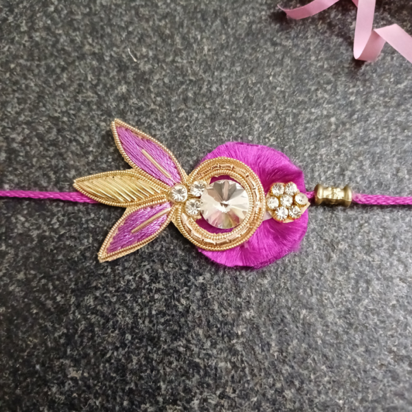 Purple Stone Jardosi Rakhi featuring intricate Jardosi and Resham work with a beautiful stone centerpiece