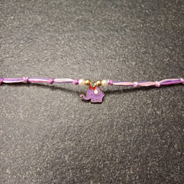 Pastel purple elephant charm rakhi on multicolor resham thread with bead accents