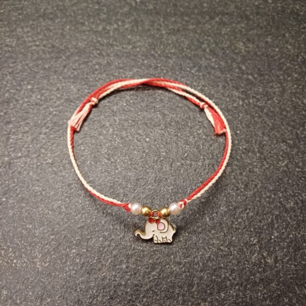 Ivory elephant enamel charm rakhi on red-white resham thread with bead accents