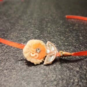 Orange Bloom Resham Rakhi with sequins, mirrors, and resham thread on orange base