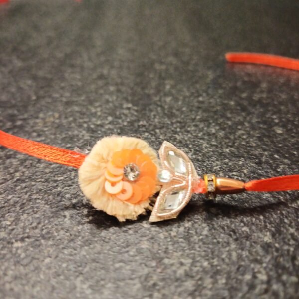 Orange Bloom Resham Rakhi with sequins, mirrors, and resham thread on orange base