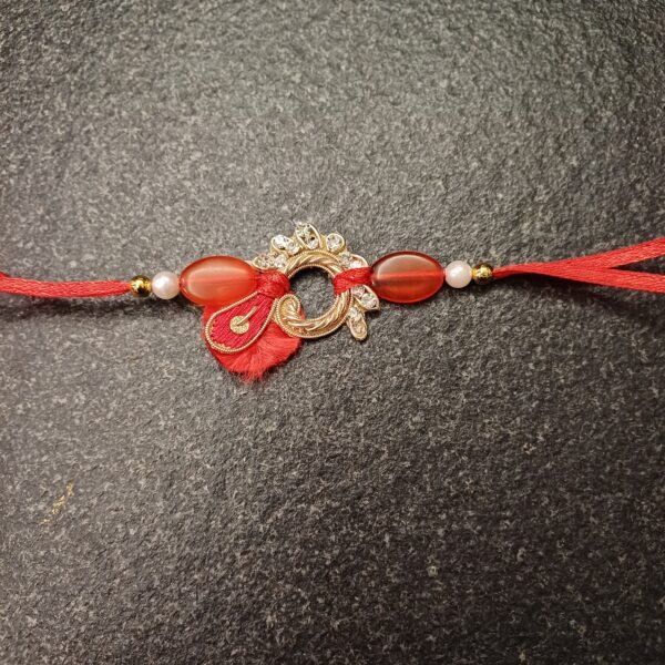 Crimson Loop Resham Rakhi with red thread and circular golden embellishment