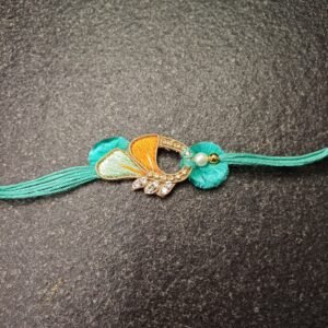 Teal Wing Resham Rakhi with embroidered wing design and pearl bead on teal thread for Raksha Bandhan.