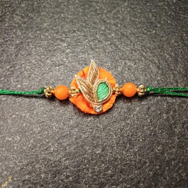 Harvest Glow Resham Rakhi with orange-green thread and golden motif for Raksha Bandhan