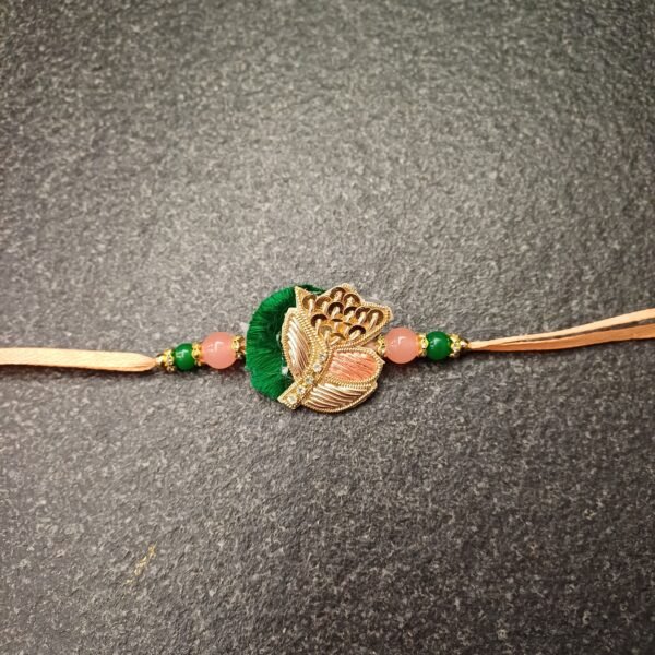 Peach Leaf Resham Rakhi with green resham thread, golden leaf design and bead detailing