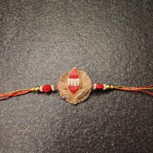 Handmade Sacred Leaf Resham Rakhi with red thread and pearl detailing