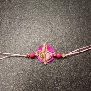 Rosy Leaf Resham Rakhi with pink base, gold detailing, and decorative pink beads for Raksha Bandhan