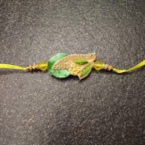 Floral Dew Resham Rakhi with embroidered green and yellow leaf motif and yellow thread
