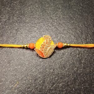 Golden Paisley Resham Rakhi with yellow-orange thread and paisley motif – Gift Elegantly