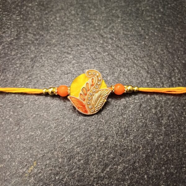 Golden Paisley Resham Rakhi with yellow-orange thread and paisley motif – Gift Elegantly
