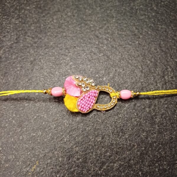 Golden Loop Resham Rakhi with pink beads and yellow resham thread, handmade for Raksha Bandhan.