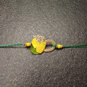 Sparkling Bond Resham Rakhi with yellow thread, green base, and decorative loop motif