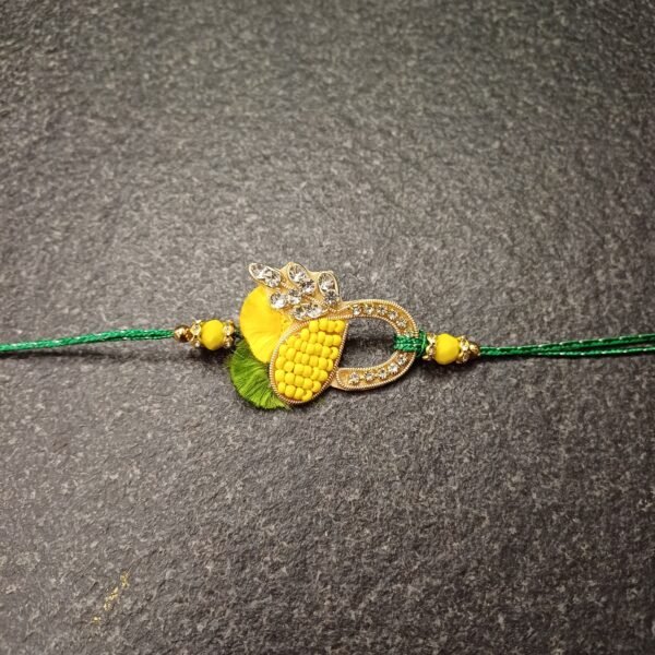 Sparkling Bond Resham Rakhi with yellow thread, green base, and decorative loop motif