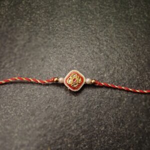 Regal Square Kundan Rakhi with red-yellow thread and golden kundan center