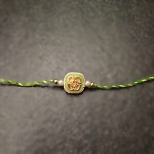 Emerald Grace Kundan Rakhi with green thread and square gold-tone design