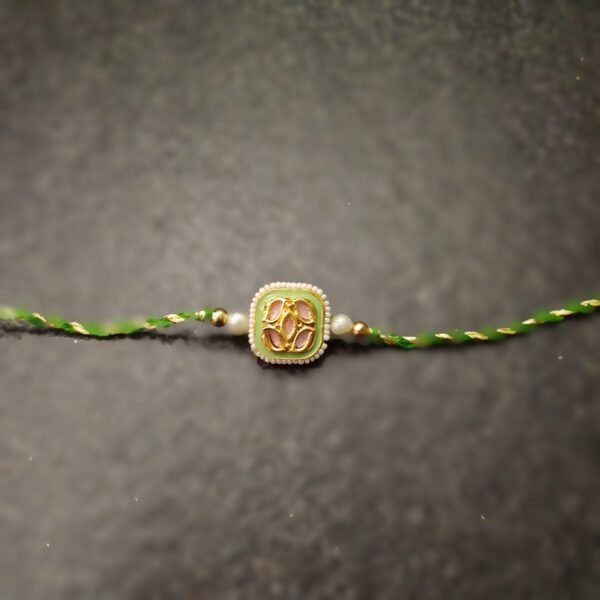 Emerald Grace Kundan Rakhi with green thread and square gold-tone design