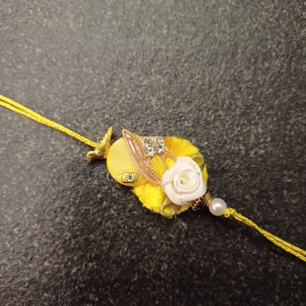 Yellow floral embroidered rakhi on resham thread with rose blossom charm