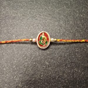 Red resham thread rakhi with enamelled Lord Ganesha centerpiece and roli-chawal pouch