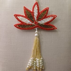 Hand-embroidered red lotus rakhi with pearl tassel on resham thread