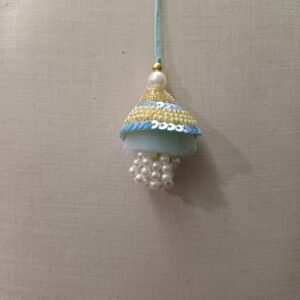 Sky-blue resham tassel rakhi with pearl and bead accents for bhabhi