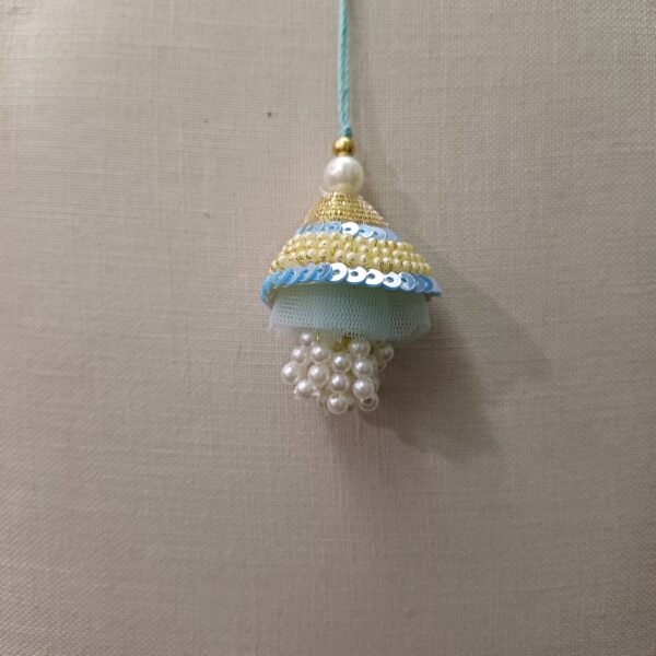 Sky-blue resham tassel rakhi with pearl and bead accents for bhabhi
