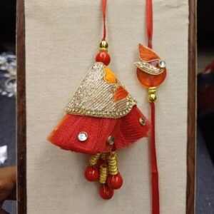 Scarlet Festive Rakhi Pair with cone-shaped bhabhi rakhi, red and orange colour theme, mirror work and thread embroidery