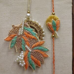 Harvest Leaf Rakhi Pair with orange, green, and gold embroidery and pearls