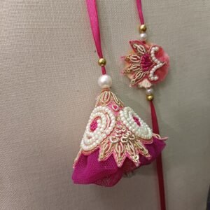Royal Pink Tassel Rakhi Pair for Bhaiya and Bhabhi with pearls, embroidery, and handmade net detailing