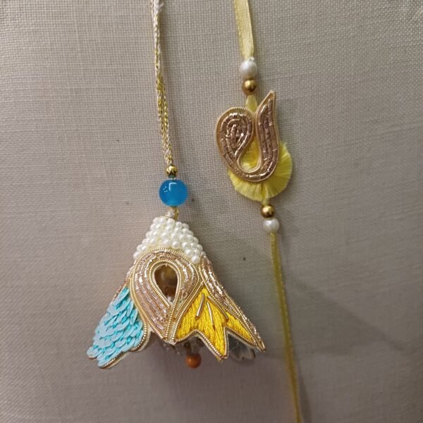 Handmade Pearl Glory Pair Rakhi for Bhai and Bhabhi in blue, gold, and pearl design with tassel and embroidery