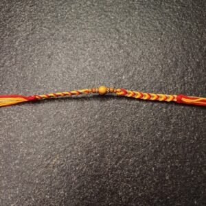 Spiritual moli rakhi with wooden bead on red and yellow braided thread