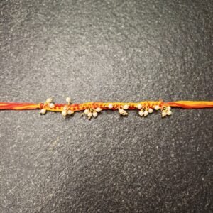 Dangling Pearl Moli Rakhi with red and orange thread and pearl cluster detailing