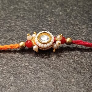 Golden Pearl Kundan Rakhi with pearl and kundan detailing on dual-tone thread